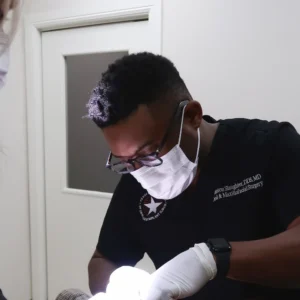 Dr. Slaughter doing an assessment for smile improvement